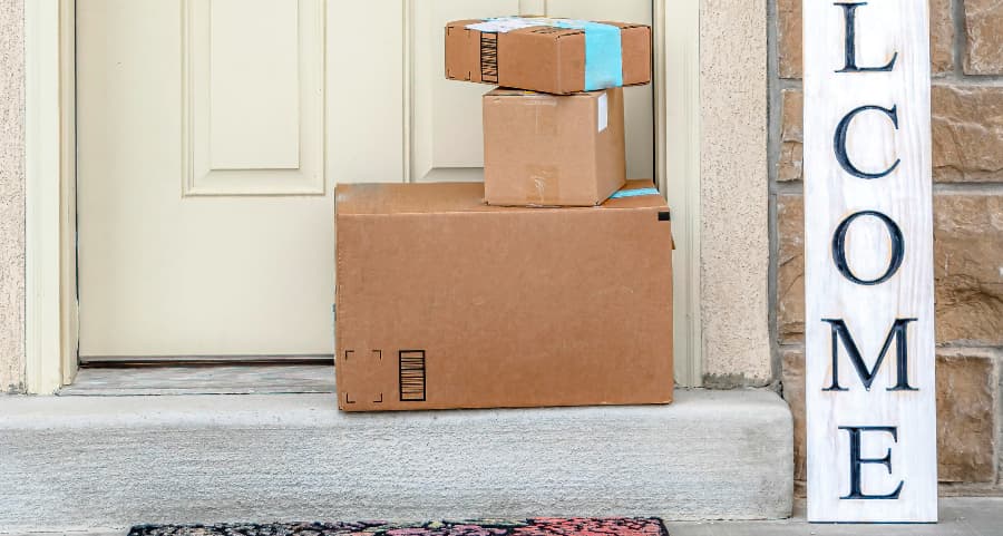 Boxes by the door of a residence with a welcome sign in Eugene